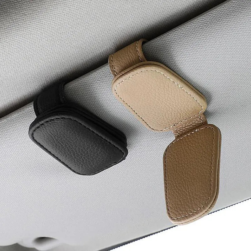 Car sunglasses clip holder made from PU leather in various colours, clipped to a sun visor.