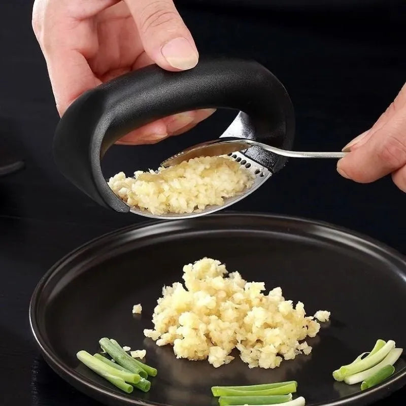 Stainless steel garlic press with non-slip handle in available colours crushing garlic