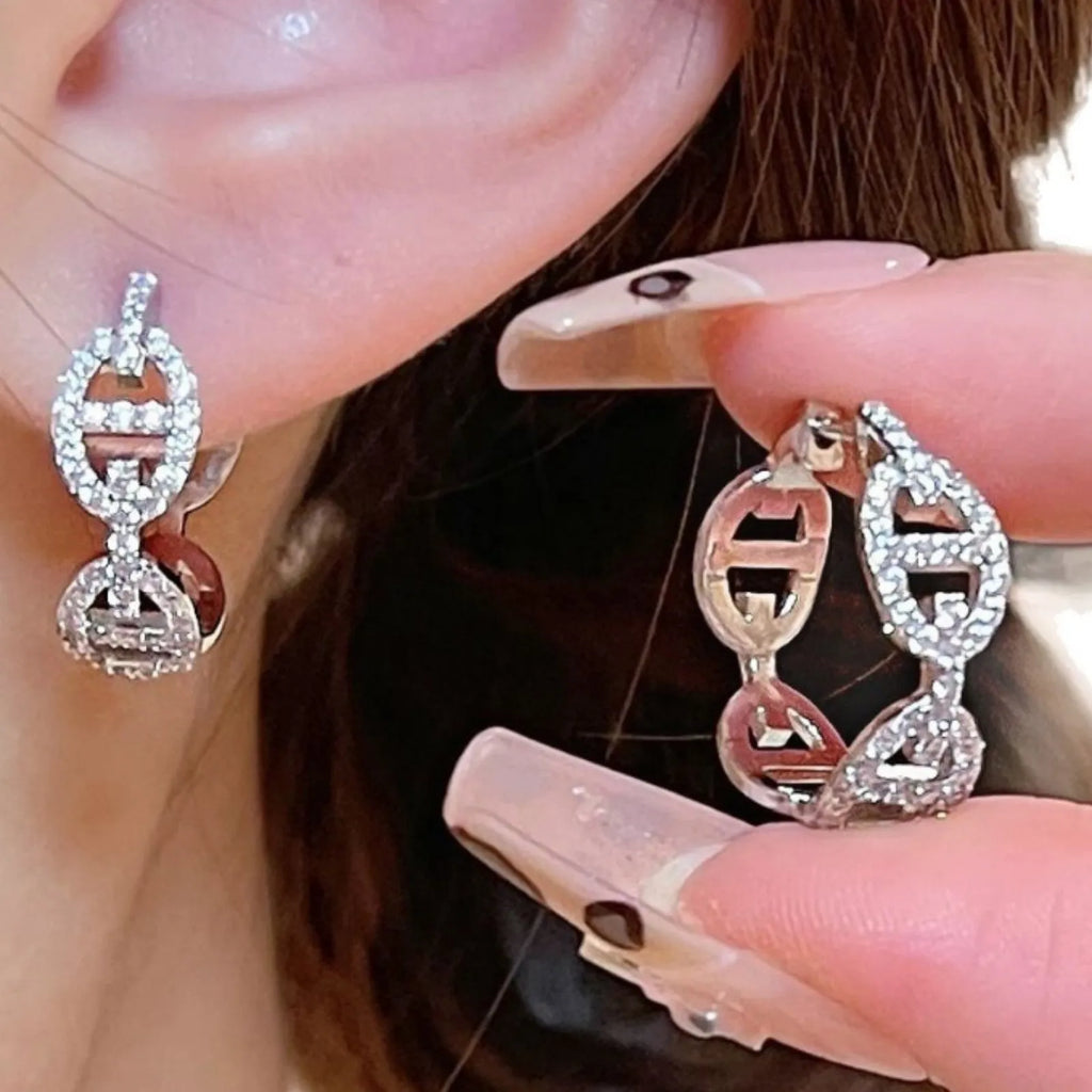 A pair of casual ladies earrings in thick gold plating with a diamond accent, shown in silver, gold, and rose gold colour options