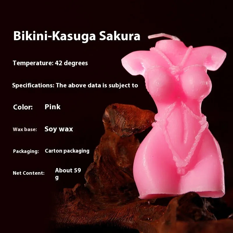 Low temperature soy wax massage candle in a bikini shape, shown in rose red, spring pink, and lilac purple colours.