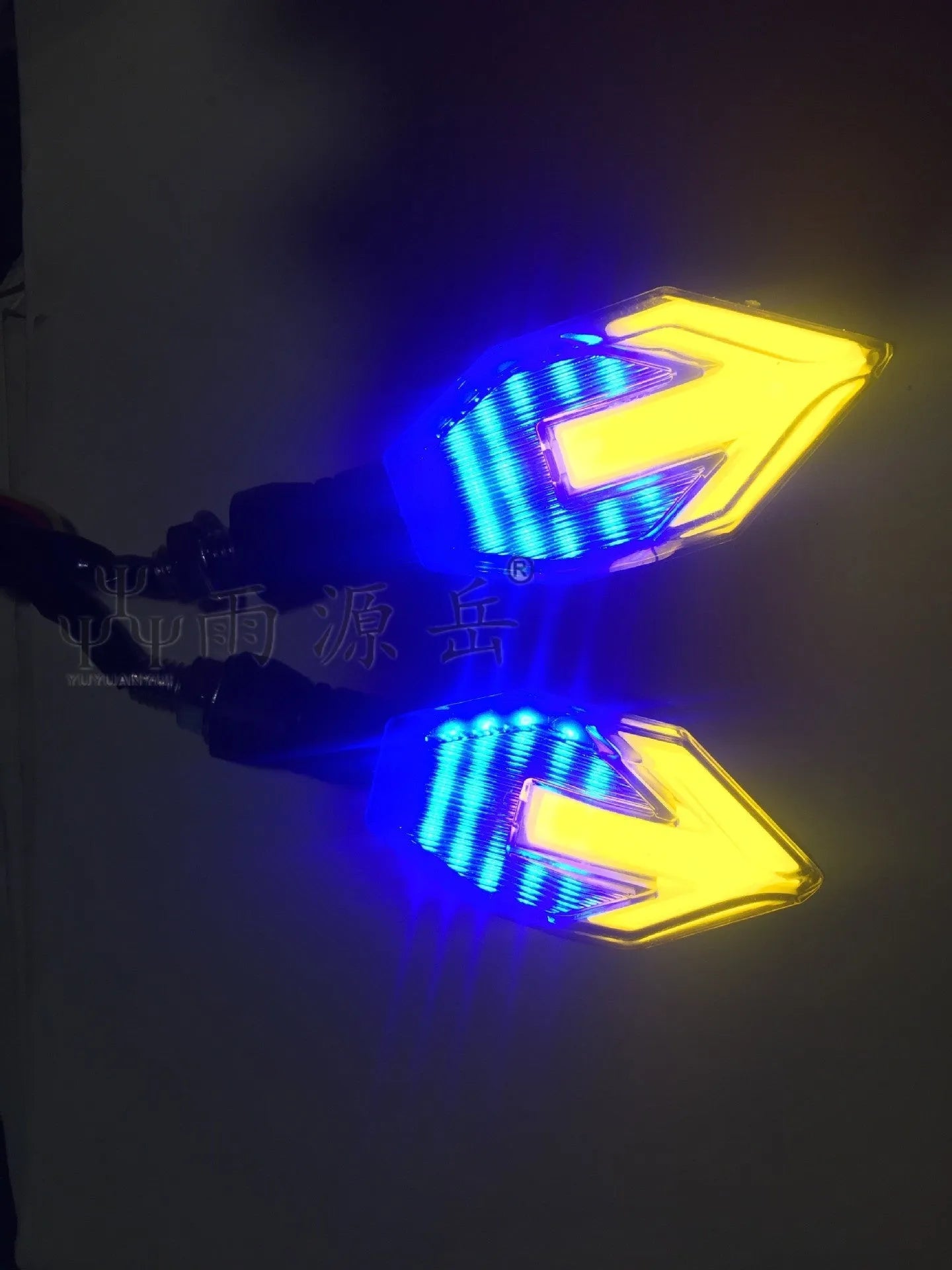 Arrow-shaped 12V LED motorcycle turn signal light in yellow with choice of blue, red, or white accent.