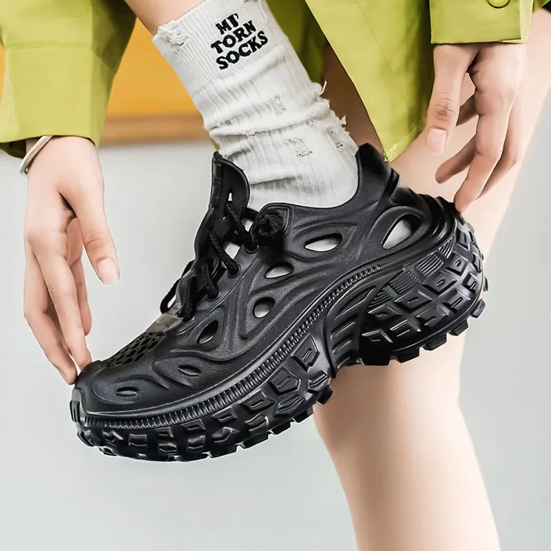 Men's black EVA sandals with thick sole, covered heel, and breathable hollow-out upper design.