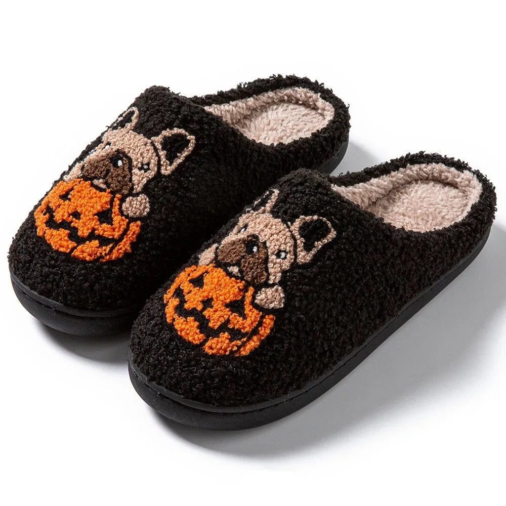 Black and white Halloween slippers with pumpkin pattern, plush lining, and textured non-slip rubber soles.