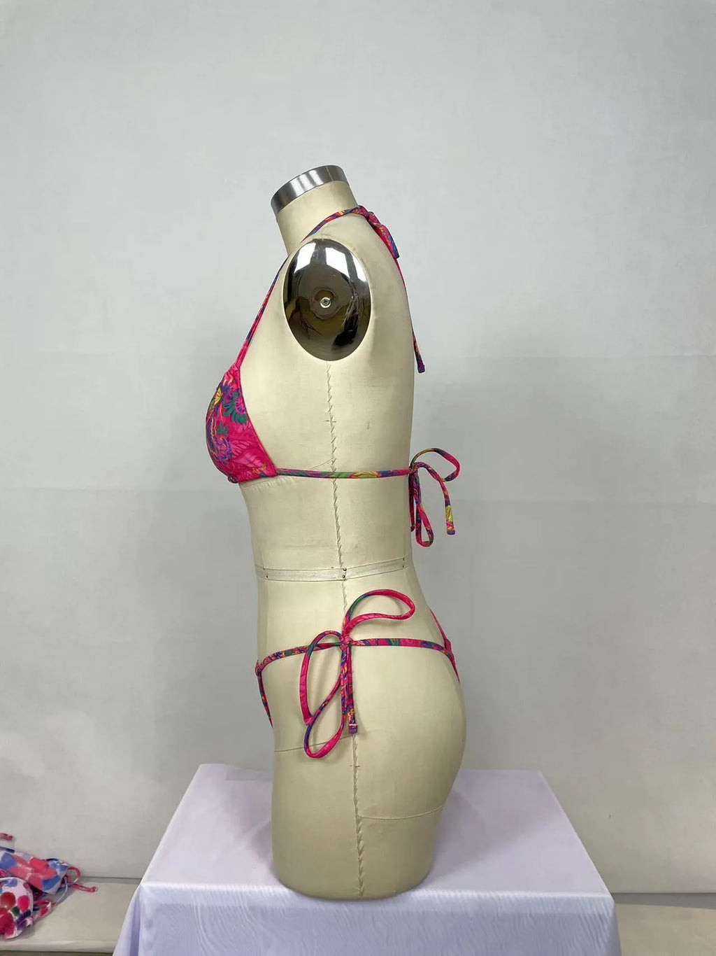 Pink women's bikini two-piece set with printed pattern on nylon fabric.