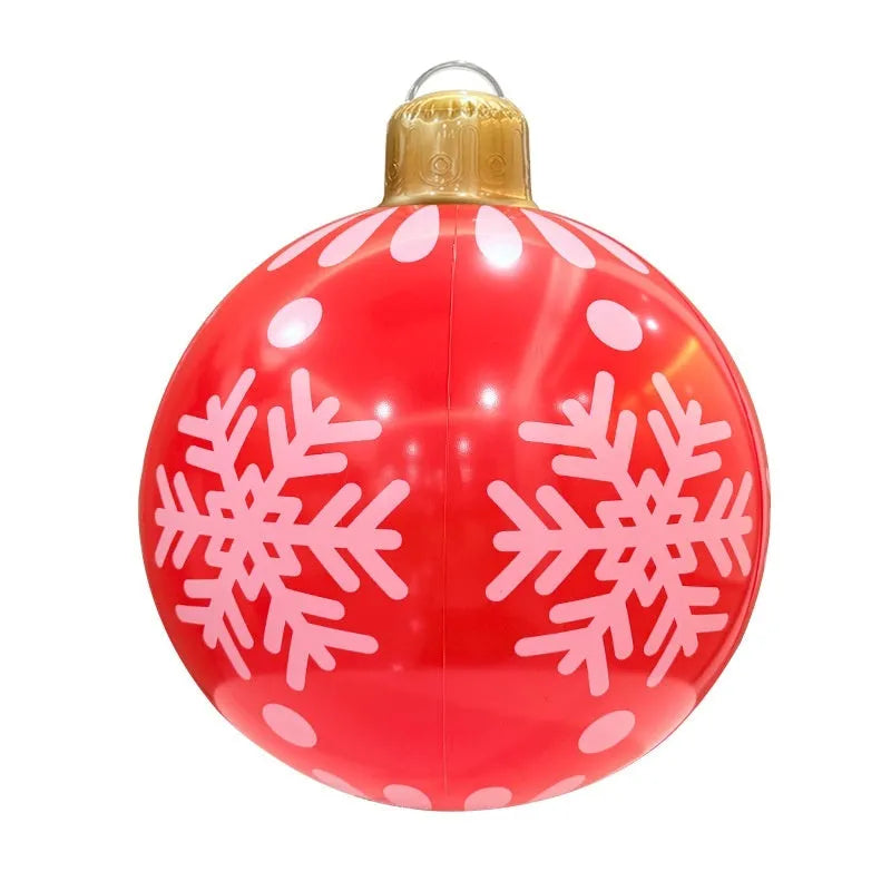 Large red inflatable Christmas ball with flash function displayed on a green garden lawn.