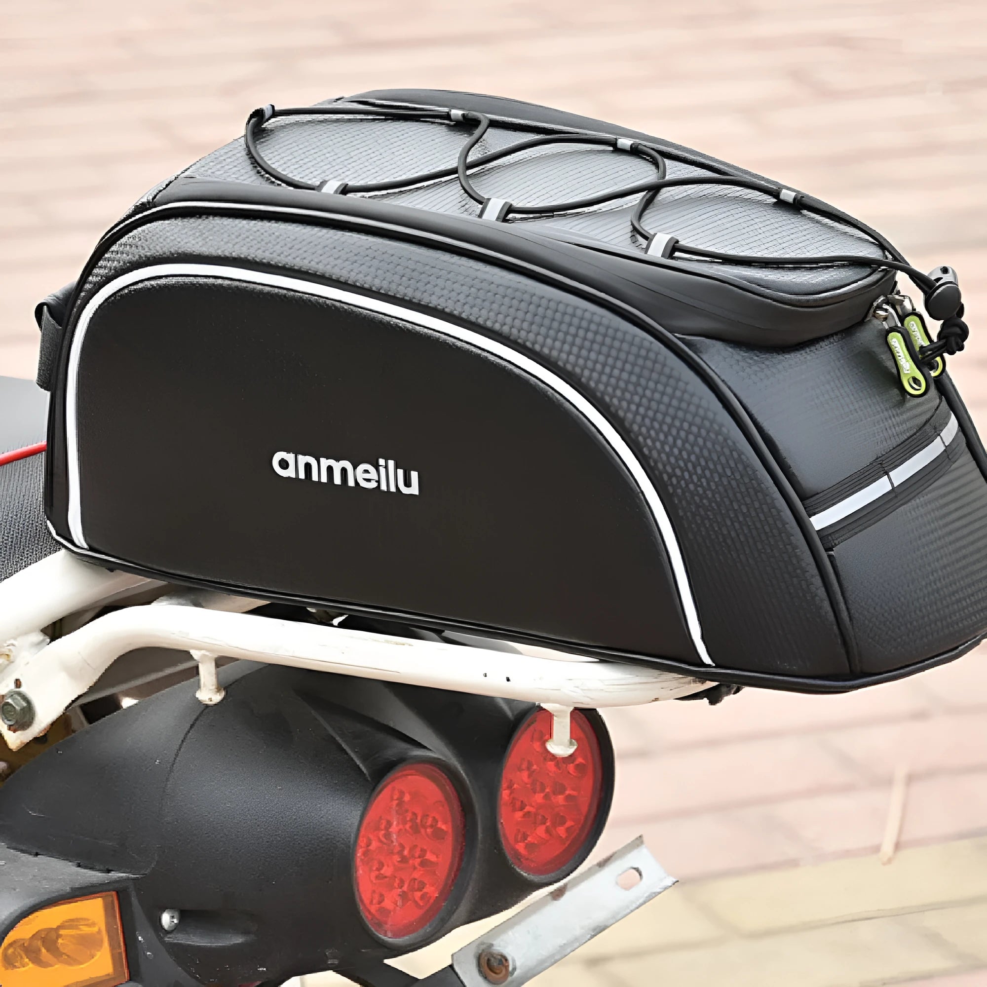 Black waterproof PU leather bicycle rack bag mounted on a bike rear rack, showing its 8-litre capacity.