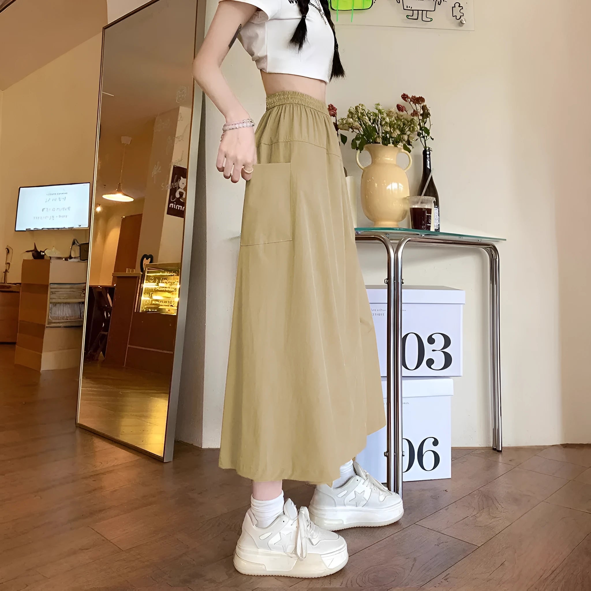 Camel-coloured women's wide leg skirt with elastic waistband, shown on hanger