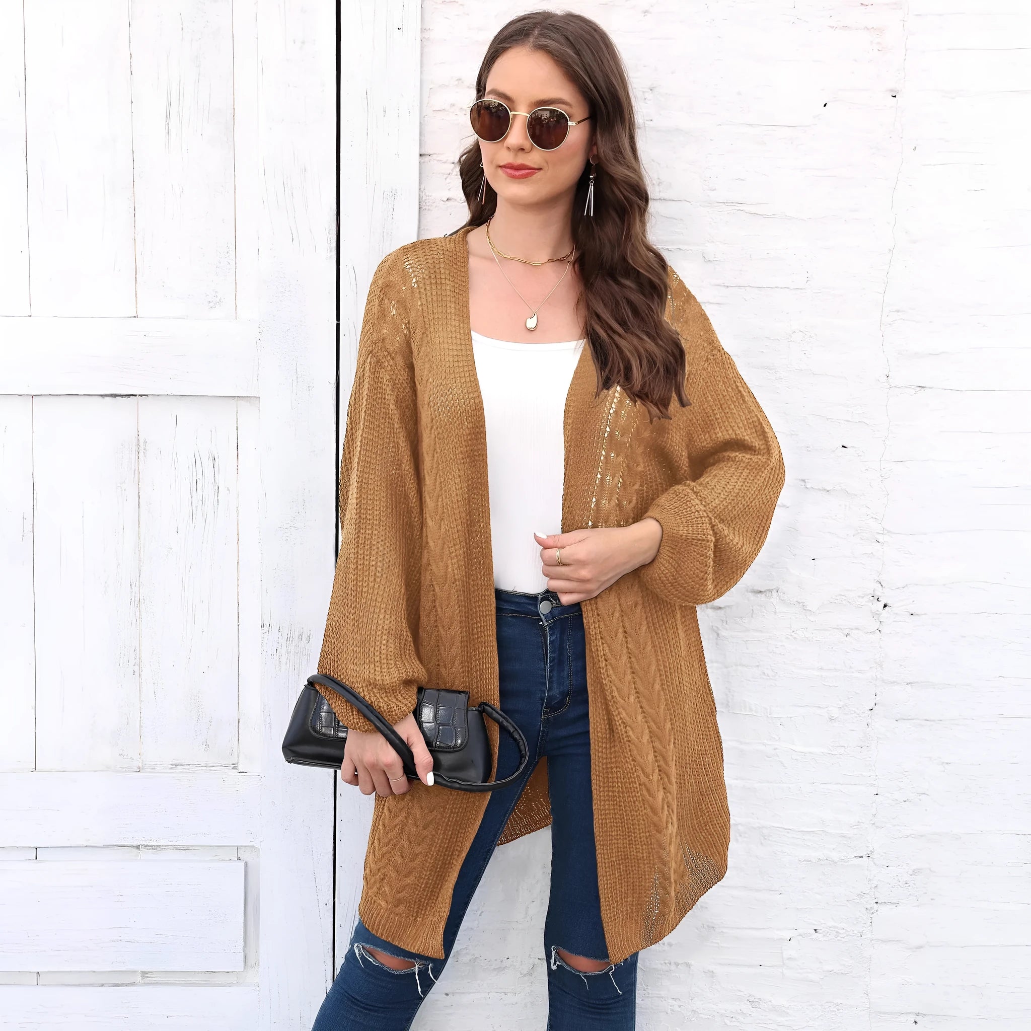 Women's loose-fit acrylic sweater coat in a solid colour, shown in light grey.