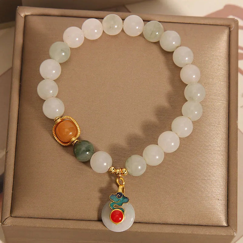 Women's ice jade crystal bracelet with pearl accents and a Xiangyun peace jade buckle.