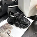 Women's creamy white low-top wedge sneakers with cross straps and a thick sole on a neutral background.