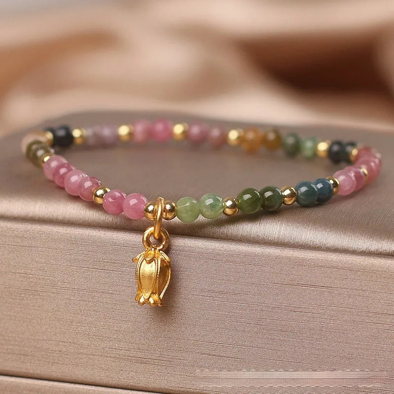 Natural tourmaline beaded floral anklet shown as adjustable bracelet on woman's wrist