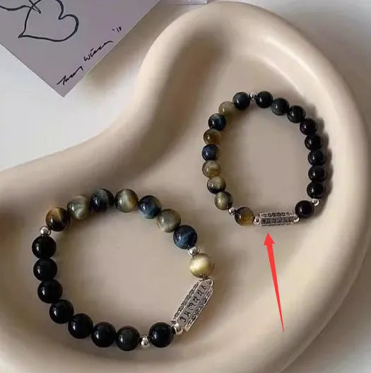 Sterling silver bracelet with obsidian and tigereye stone beads showing geometric round design and mantra engraving