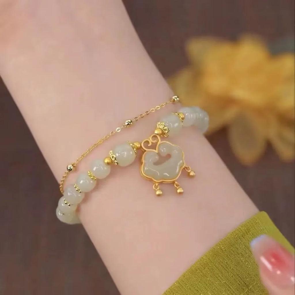 Green women's bracelet with traditional Chinese xiangyun lock pendant and safety closure