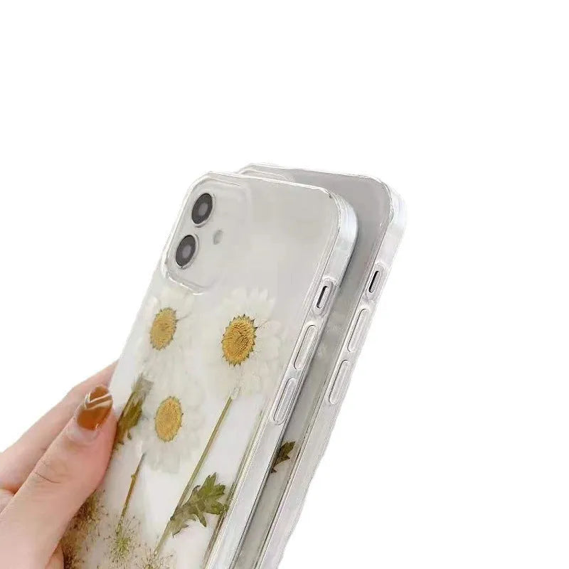 White TPU iPhone case with epoxy daisy floral pattern on back, shown on iPhone model