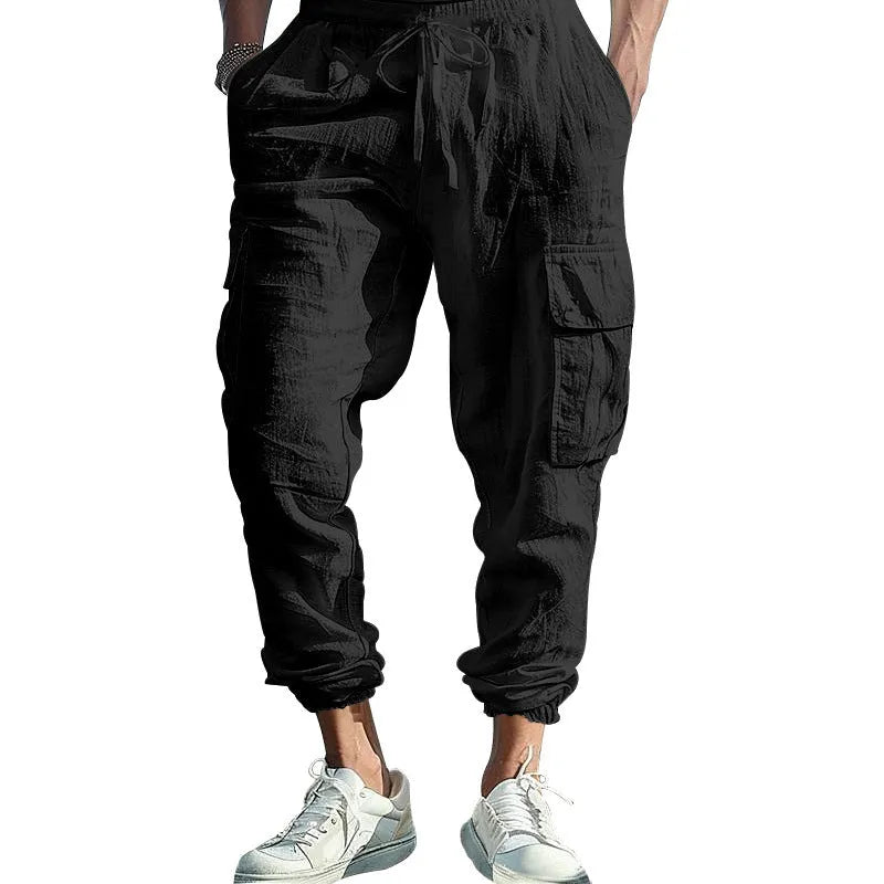 Men's solid colour linen casual trousers with ankle ties and multiple pockets in a loose fit.