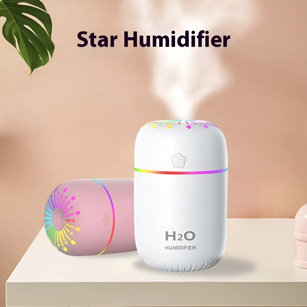 Small white USB portable humidifier with fireworks design on a wooden desk