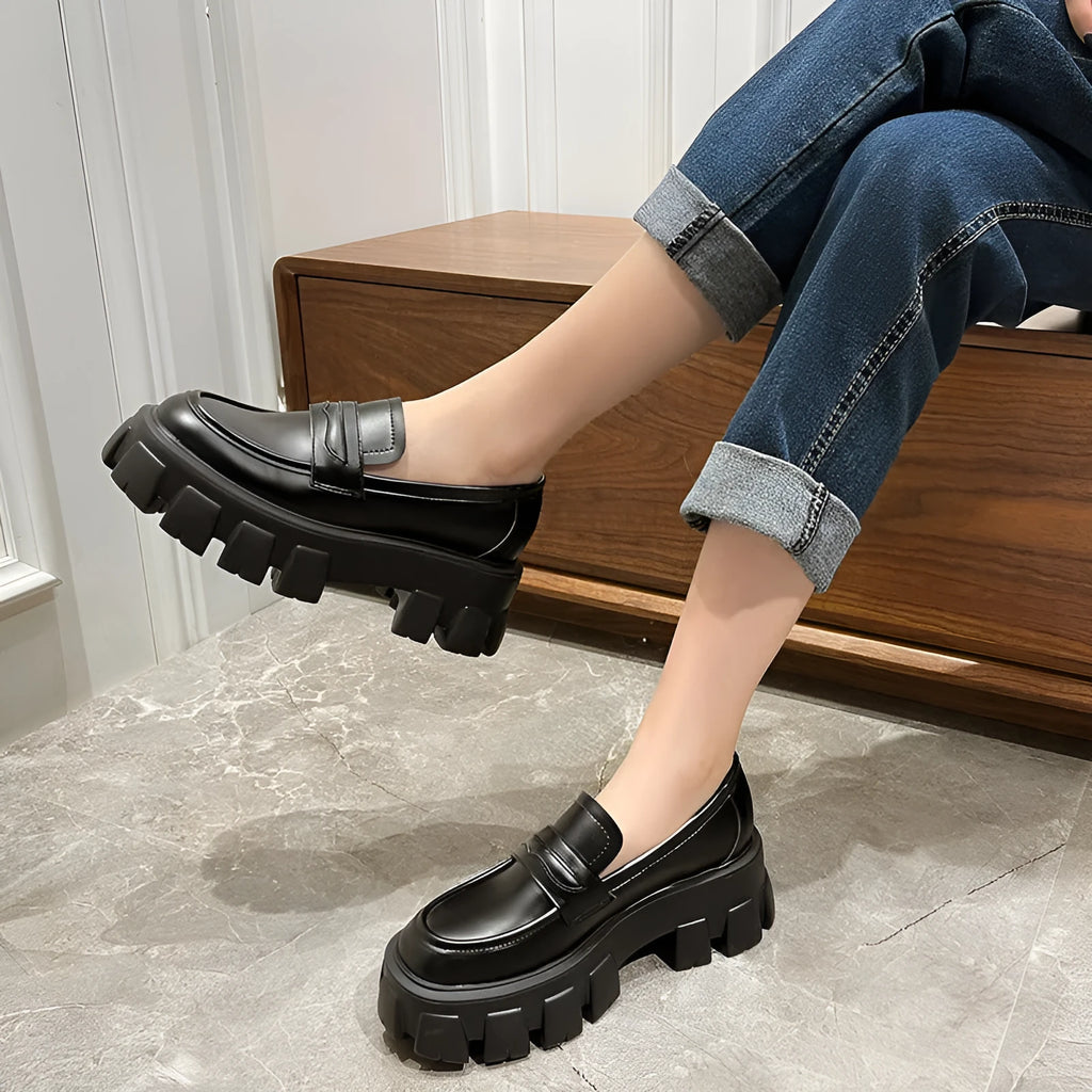 British style wide-fit loafers in patent leather with a muffin base heel and rubber sole.