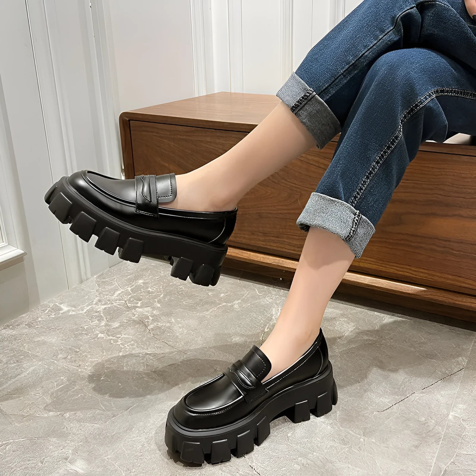 British style wide-fit loafers in patent leather with a muffin base heel and rubber sole.