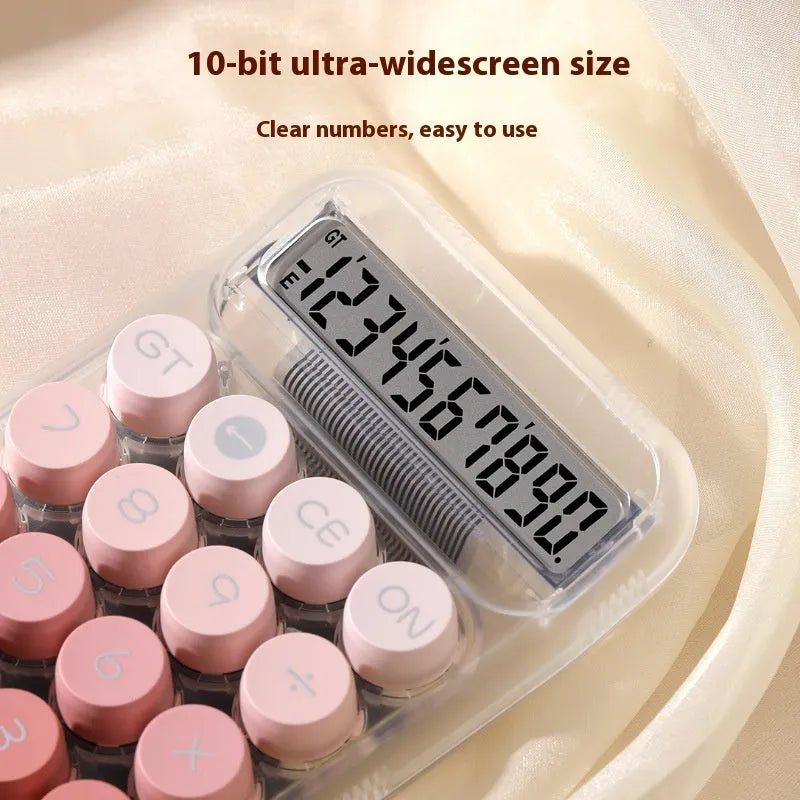 Round mechanical keyboard calculator in a muted colour with large LCD display on desk.