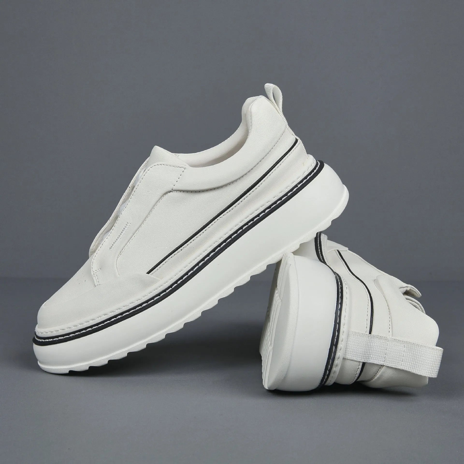 Breathable casual slip-on sneaker in black with first layer cowhide upper, platform mid heel, and sewing thread detail
