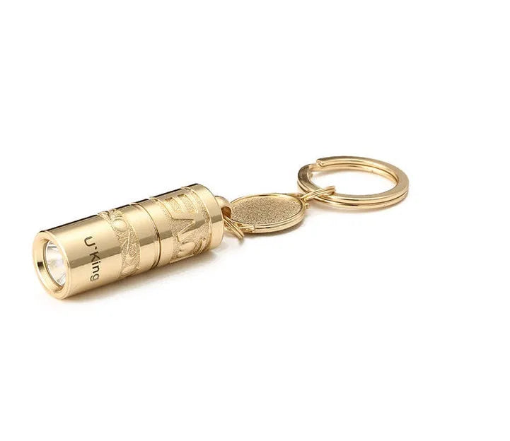 Gold-coloured zinc alloy mini portable LED flashlight on a keyring.
