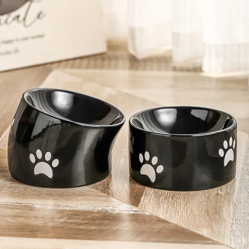 Ceramic cat bowl with high foot design and oblique mouth in cat's paw pattern