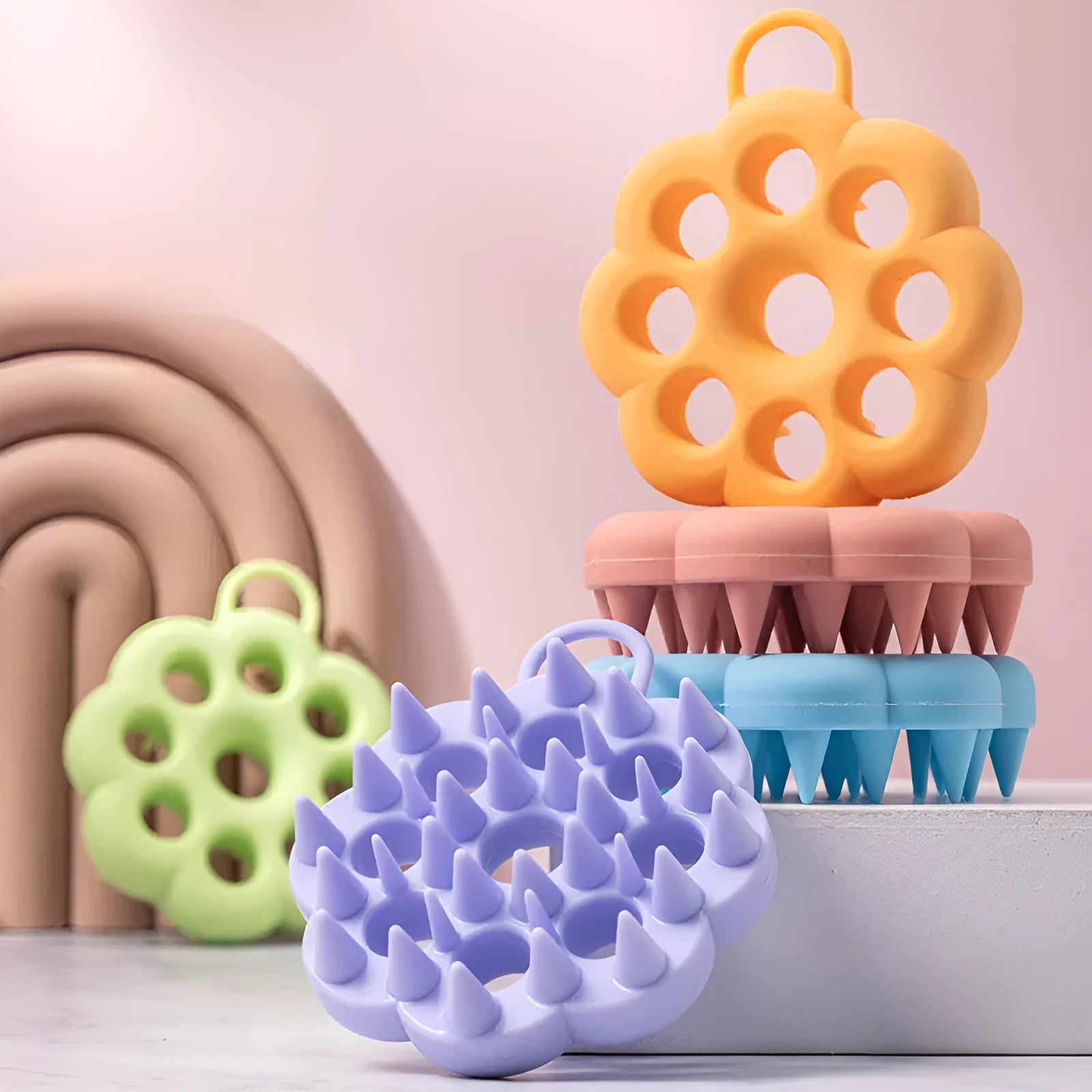 Blue silicone pet grooming brush with flexible massage bristles for wet or dry use on cats and dogs.