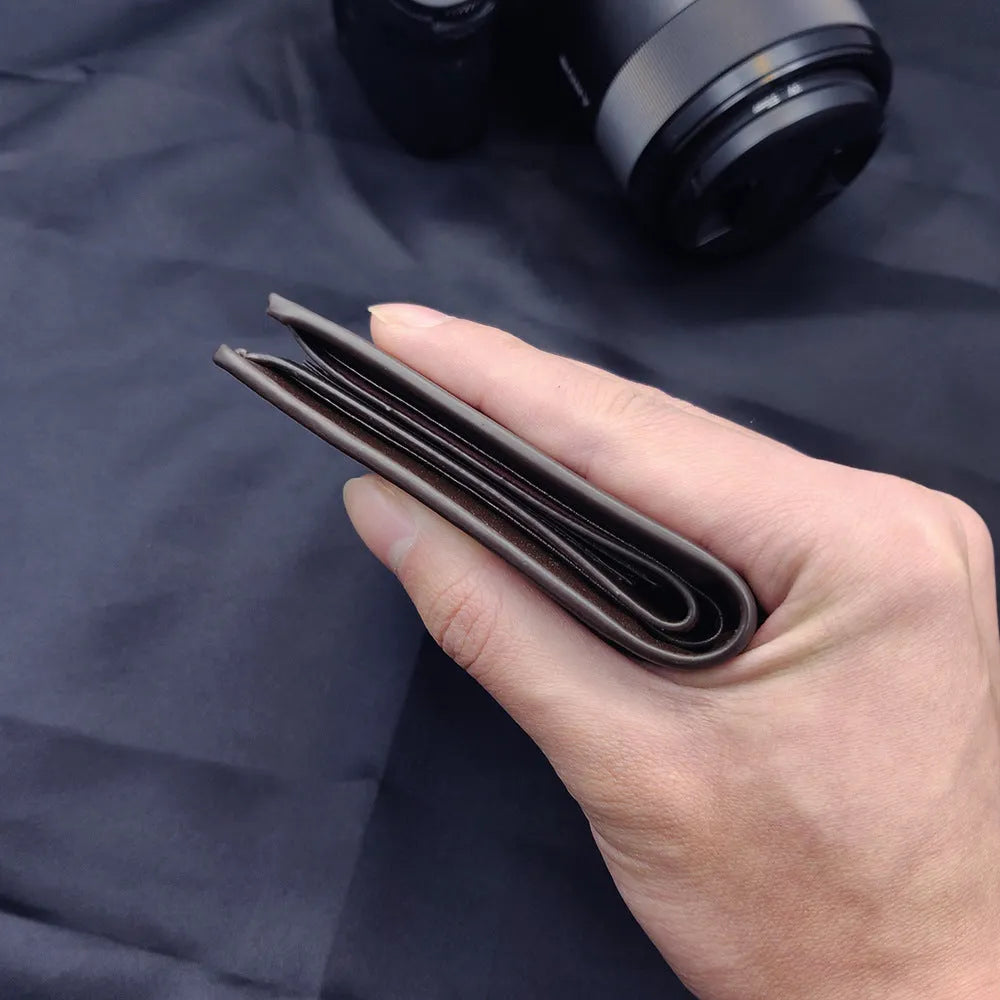 Men's leather wallet with a zipper closure, individually packaged for gift-giving.