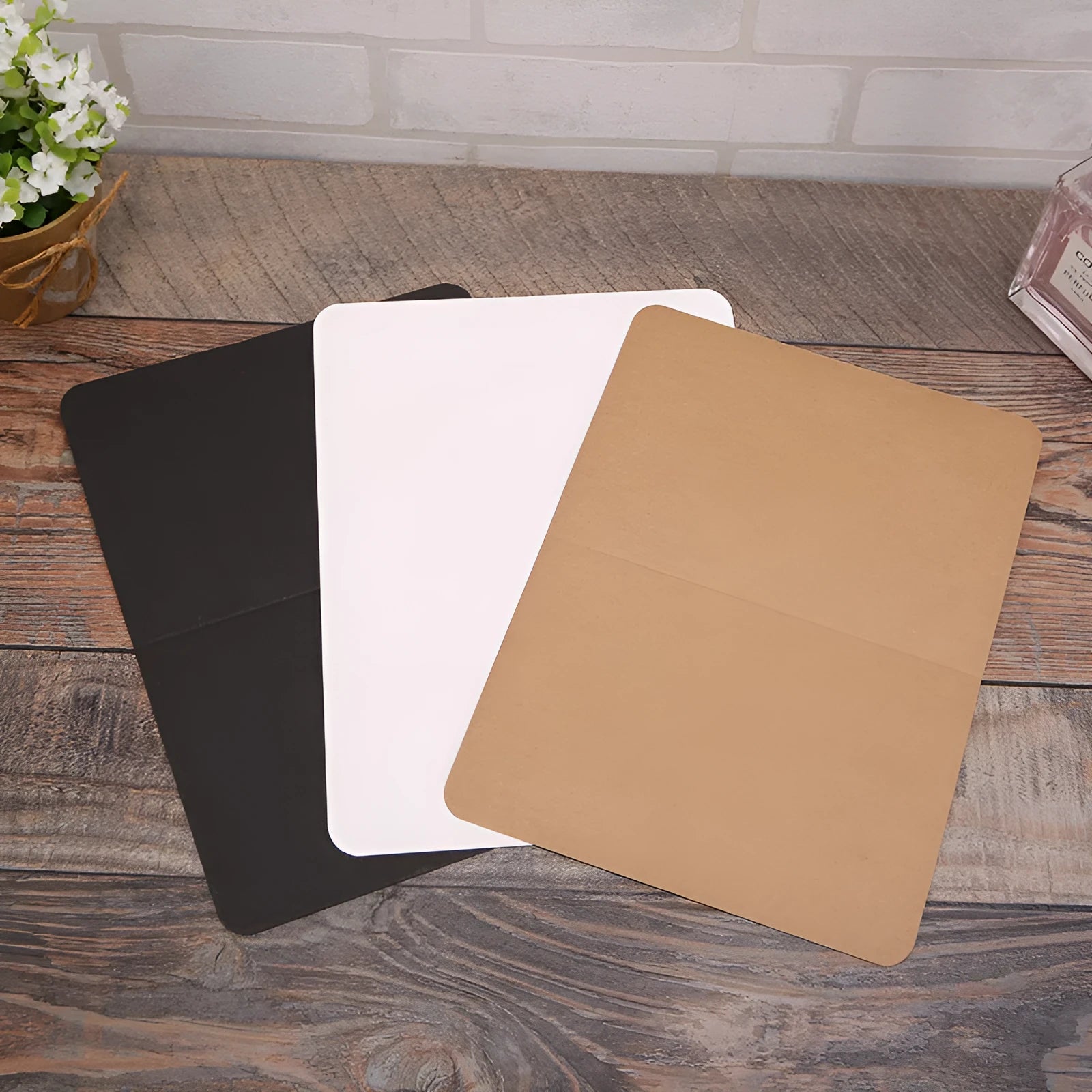 Pack of 100 plain kraft folded greeting cards in black, brown, and white, sized 10 by 15 cm.