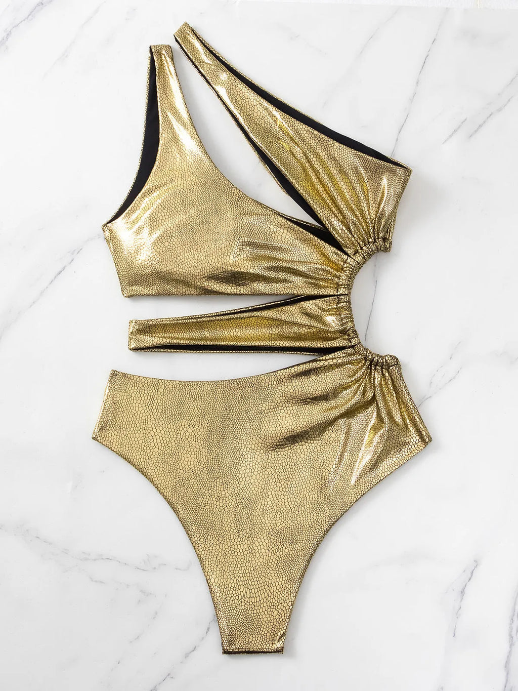 Women's gold backless one-piece swimsuit with spandex lining on mannequin