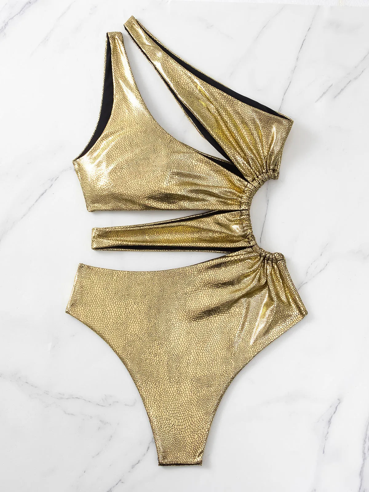 Women's gold backless one-piece swimsuit with spandex lining on mannequin