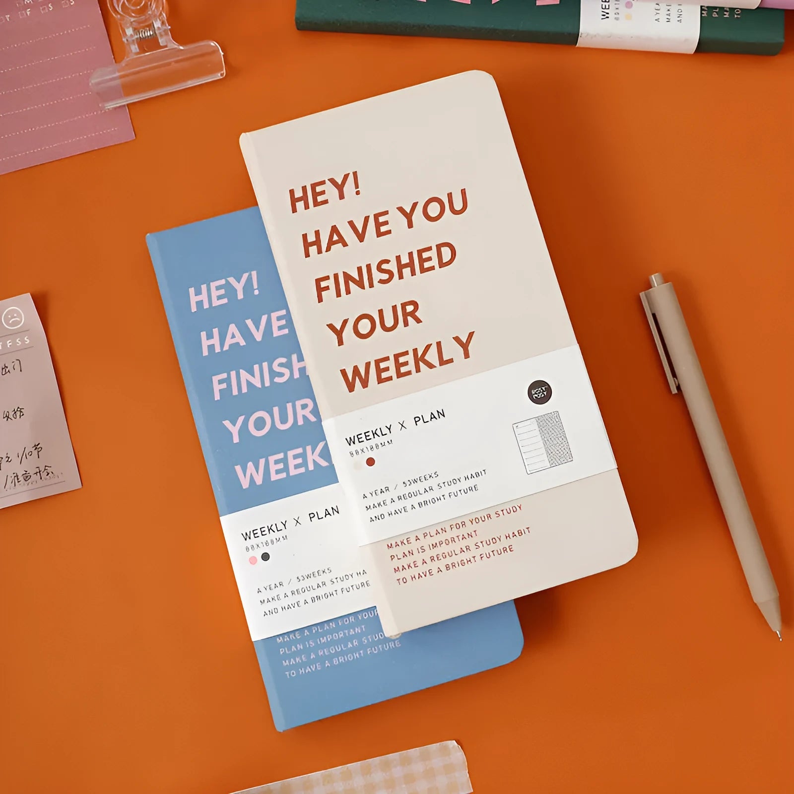 Weekly diary handbook open on a weekly planner page, showing blue cover option.
