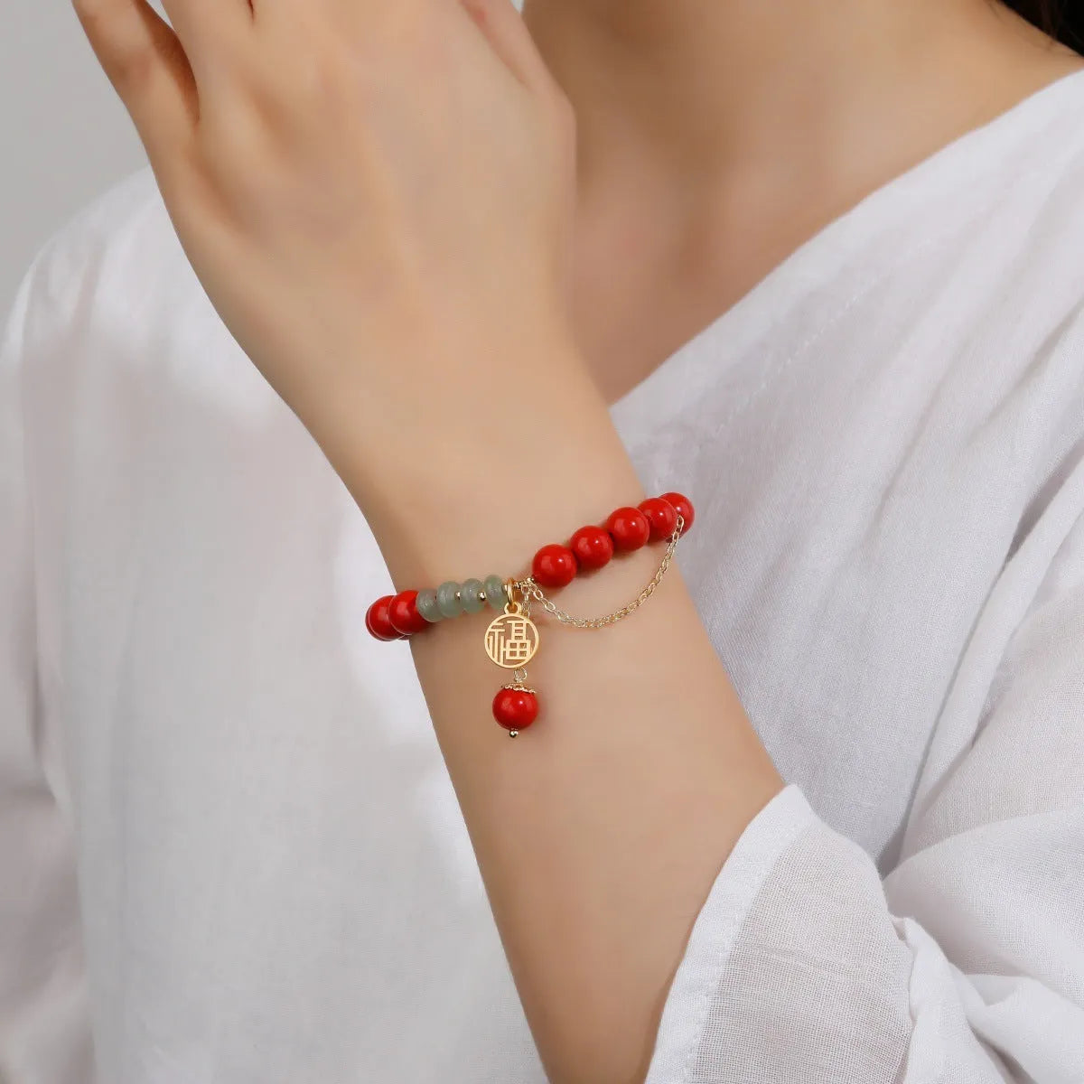 Retro red sand cinnabar bracelet with fu character charm, jade ornament, and 8mm tassel