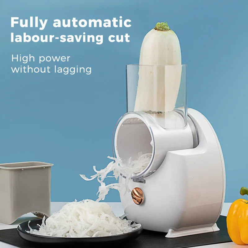 White electric kitchen vegetable slicer with multiple blades and a suction base on a countertop.