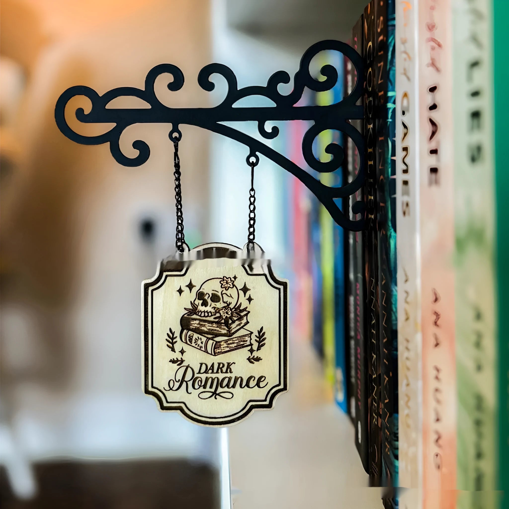 Decorative book nook divider shaped like a medieval tavern sign for shelf organisation