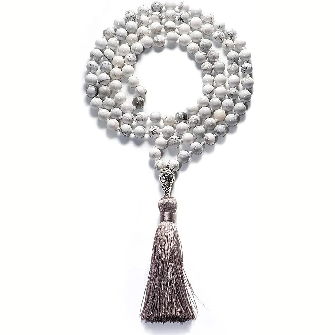 Long blue gemstone tassel necklace with agate, lapis lazuli, and turquoise beads on a geometric pendant.