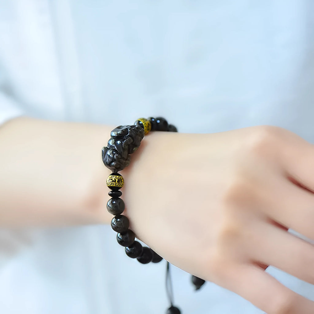 Natural golden obsidian Pi Xiu bracelet with hand-woven cord, showing four bead size options