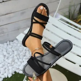 Women's black plus size sandals with a round toe, flip-toe buckle, and a cross strap over the foot.
