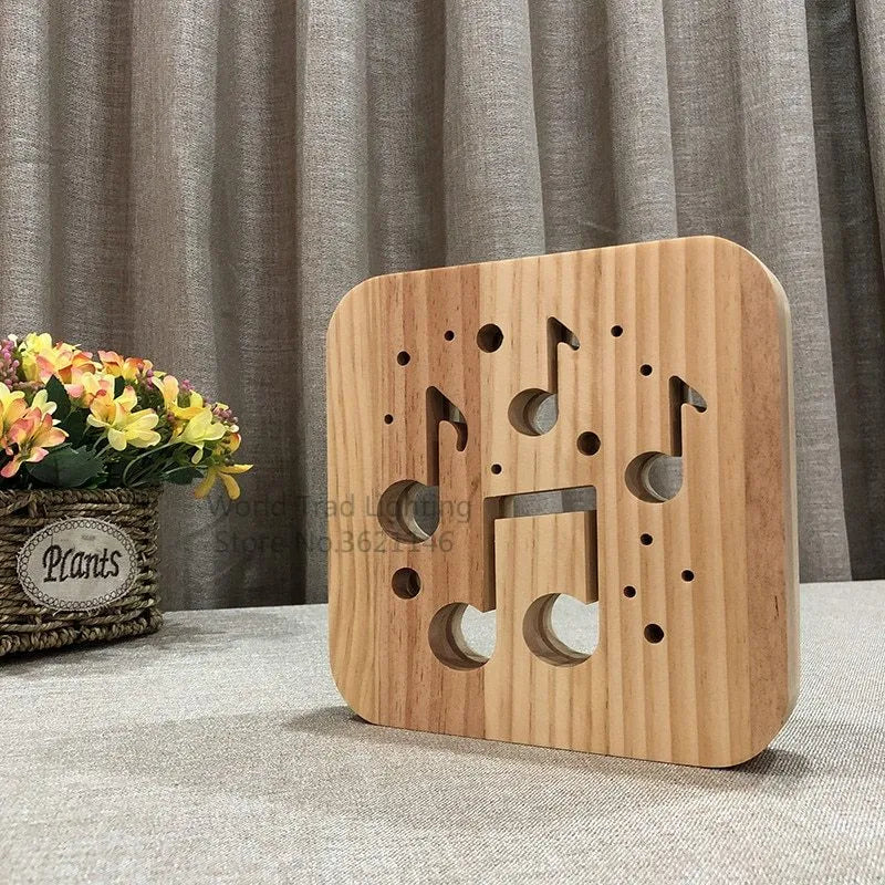 Square pine wood frame USB LED atmosphere lamp emitting warm white light on a desk.