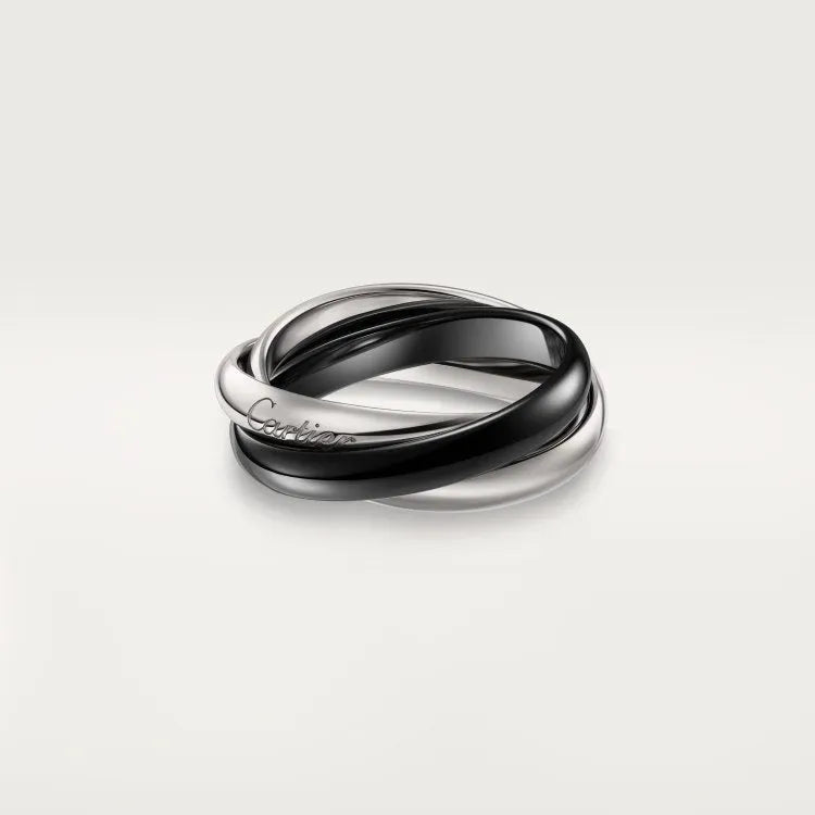 A set of two silver U-shaped geometric couple's rings, one with full diamonds and one plain, on a jewellery display.