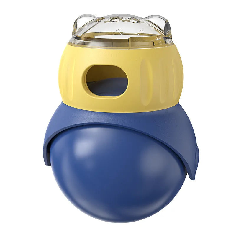 Yellow and blue plastic owl-shaped tumbler puzzle feeder cat toy on a flat surface.