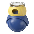 Yellow and blue plastic owl-shaped tumbler puzzle feeder cat toy on a flat surface.