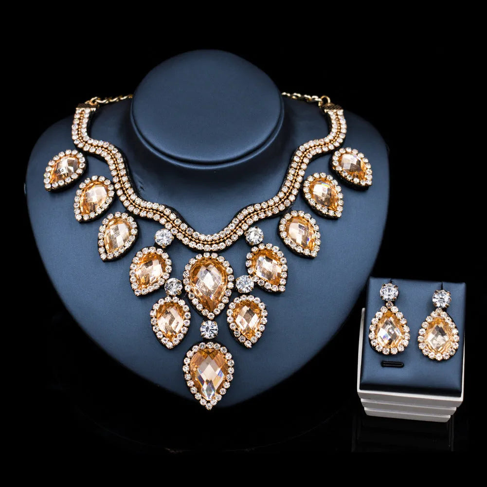 Gold finish colourful exaggerated bride necklace and earring set with royal blue accents