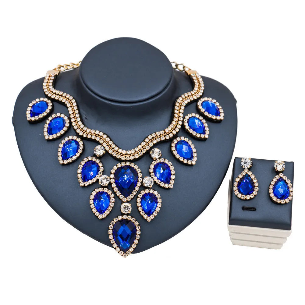 Gold finish colourful exaggerated bride necklace and earring set with royal blue accents