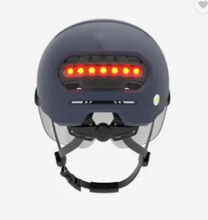 Cycling helmet with integrated LED front light and red tail light on a black PC shell.
