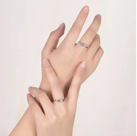 Silver adjustable heart diamond ring with geometric design on a plain background