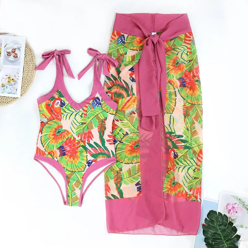 Retro pink floral print one-piece swimsuit with V-neck, covered belly and thin skirt overlay