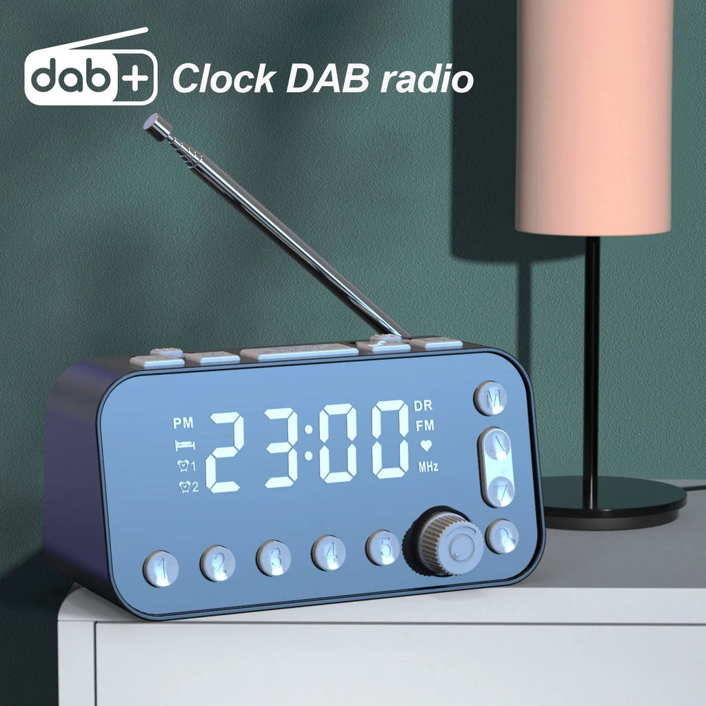 Black DAB bedside alarm clock with large LED display, pigtail antenna, and USB ports on the side.
