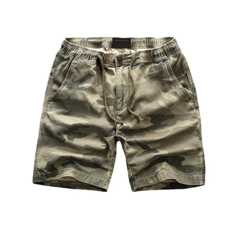 Youth cotton workwear shorts in camouflage green pattern with mid waist and zip fly.