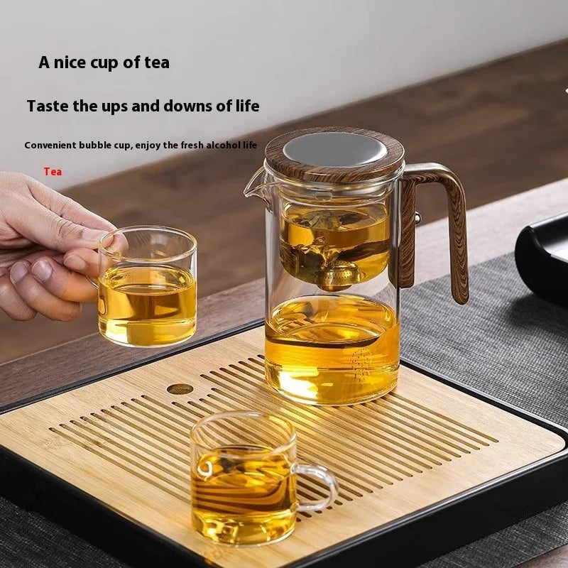 Glass teapot with magnetic tea leaf separator and wooden handle shown in new Chinese style.